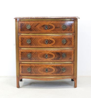 an antique wooden chest of drawers with a marble top