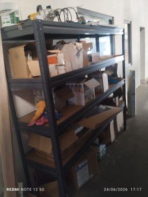 a shelf with boxes and boxes on it in a room