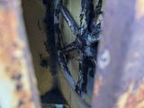 a rusted wheel in the center of a rusted out vehicle