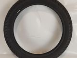 a close up of a tire on a white surface