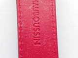 a close up of a red watch strap on a white surface