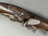 a close up of a gun with a bird on it