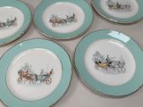 four plates with a picture of a horse drawn carriage on them