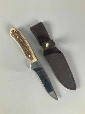 a knife that is laying next to a knife holder