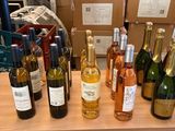 many bottles of wine sitting on a shelf in a store