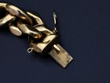 a gold chain attached to a usb device on a blue surface