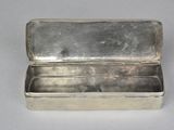 a small silver box with a lid on a table