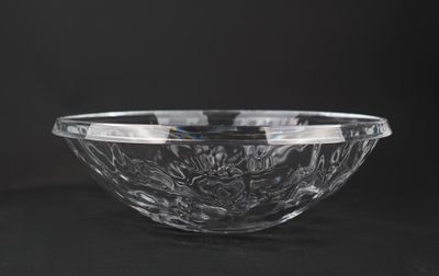 a clear glass bowl sitting on top of a black table