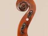 an antique violin with a scroll and a bow on a white background