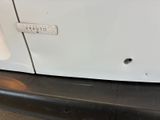 a close up of a white van with a number plate on it