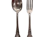 two silver spoons and a fork on a white background