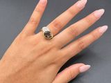 an image of a woman ' s hand with a ring on it