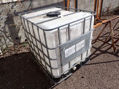 a large white container sitting on top of a metal cart