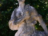 a statue of a woman holding a basket of flowers