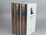 two books are stacked on top of each other in a box