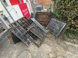 a pile of metal crates sitting on the side of the road