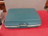 a blue suitcase sitting on a red table
