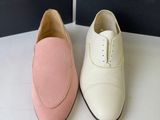 pair of white and pink shoes sitting next to each other on a table