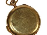 a gold colored pocket watch with a chain on it