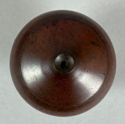 a wooden object that is on a white surface