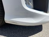 a close up of a car ' s front bumper with scratches on it