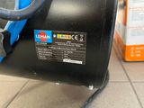 a black suitcase with a blue handle sitting on a tiled floor