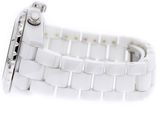 a close up of a white watch on a white surface