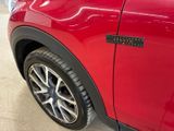 a close up of a red car with a sticker on it