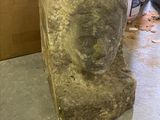a large rock sitting on the floor next to a door