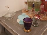 bottles and glasses on a table with a tray on top of it