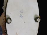 a close up of a person holding a white plate with a black background