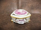 an image of a porcelain box with a flower on it