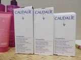 three bottles of caudalie products sitting on a table next to each other