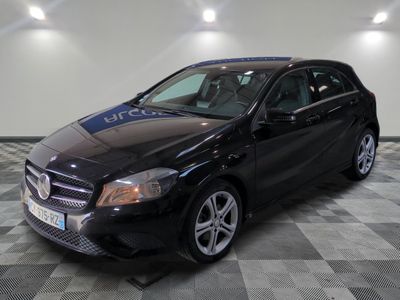 the mercedes cla is parked in a garage with a checkered floor