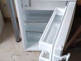 a small white table with a drawer underneath it