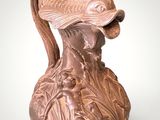 a brown vase with a fish on it on a white surface