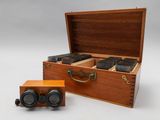 an image of a wooden box with a pair of binoculars in it