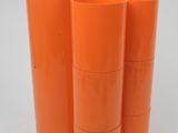 three orange plastic cups are stacked on top of each other