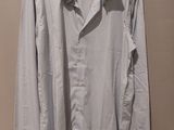 shirt hanging on a hanger on a wall in a room