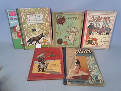 several children ' s books are lined up on a table