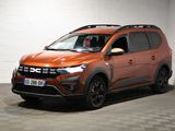 the orange car is parked in a garage with a checkered floor