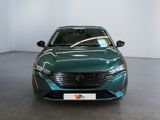 the front view of a green car parked in a showroom