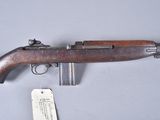 a close up of a rifle on a table with a price tag