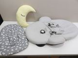 a white table topped with pillows and a stuffed animal