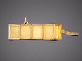 a close up of a gold plated pendant with four compartments