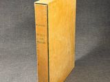 an old book sitting on top of a table next to a gray background