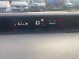 the dashboard of a car with a lot of cars in the background