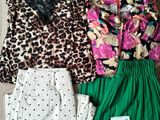 three pieces of clothing laid out on the floor next to a bag