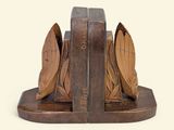 a wooden bookend with a book and a bird on it