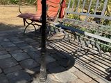 a bench and a table on a brick patio